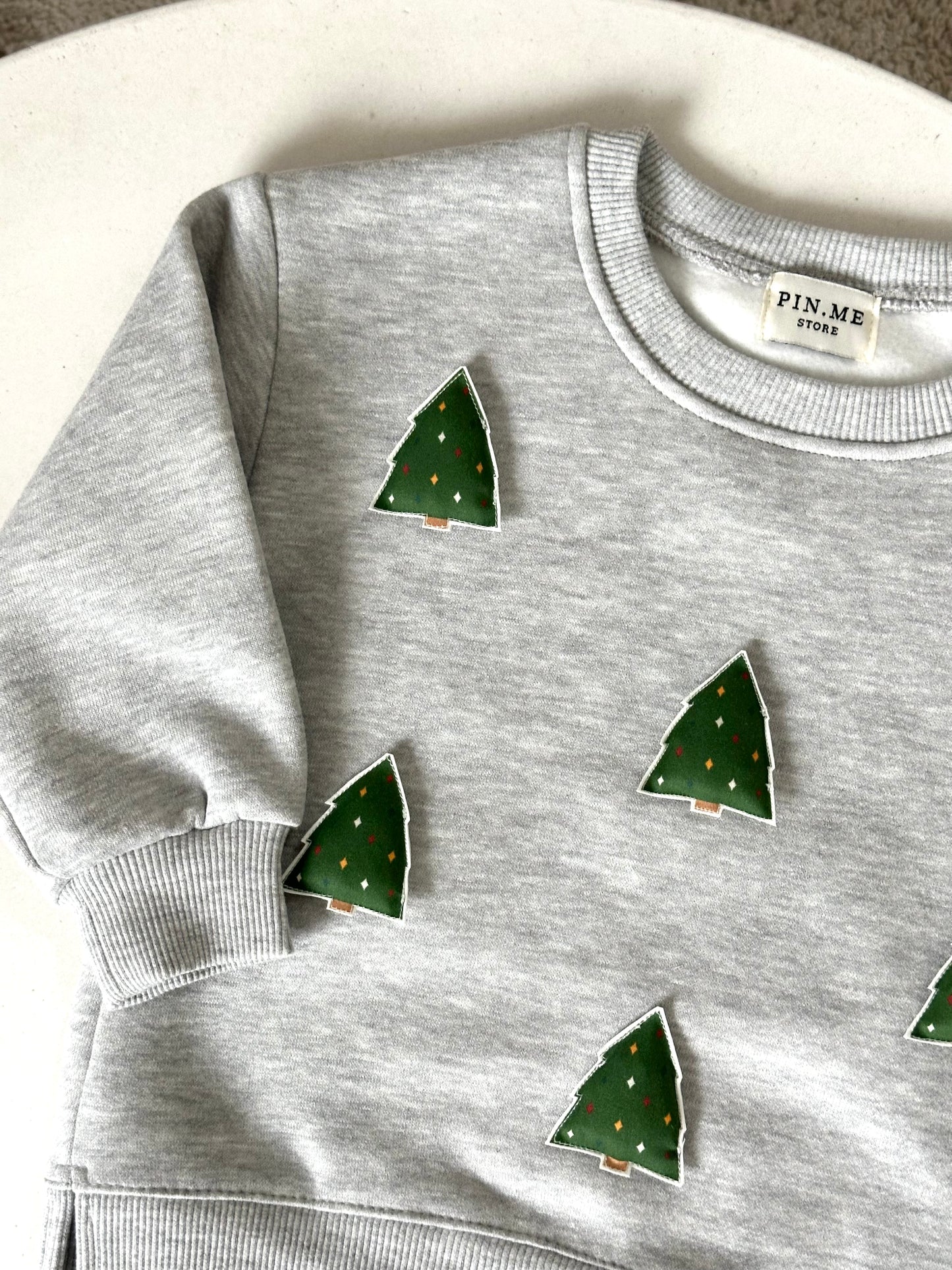 Gray sweatshirt with two toys